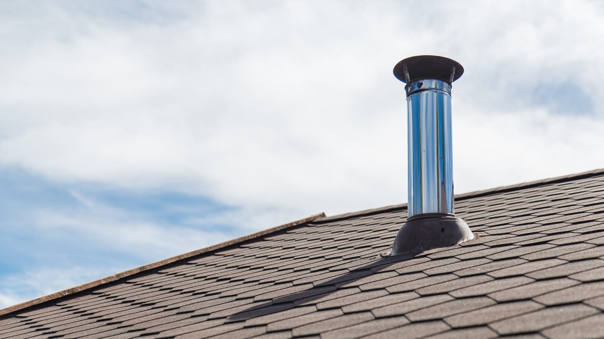 Chimney pipe from stainless steel on the roof of the house